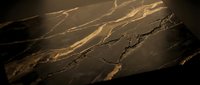 Luxurious dark marble surface with elegant golden veining patterns creating sophisticated natural stone texture for premium interior design applications.