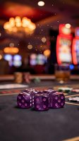 Purple dice on casino gaming table with blurred slot machines and warm golden lighting in background, suitable for gambling, entertainment, and gaming industry content.