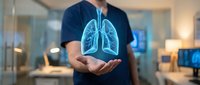 Man holding glowing blue lungs hologram in modern office environment representing respiratory health, medical technology and healthcare innovation.