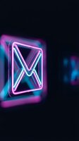 Glowing neon envelope icon with vibrant pink and blue lights on dark background for digital communication and email marketing concepts.