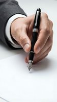 Businessman hand holding luxury fountain pen signing document on white paper, close-up view of elegant writing instrument.