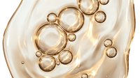 Transparent liquid with floating golden bubbles and spheres creating an abstract cosmetic or skincare serum effect, isolated on white background for product packaging and beauty design use.