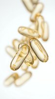 Golden omega-3 fish oil capsules scattered on white background for health and wellness supplements nutrition dietary support.