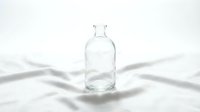 Empty glass bottle with cork stopper isolated on white background, casting shadows. Suitable for product packaging, pharmaceutical, beverage, and cosmetic design mockups.