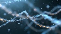 Glowing blue and gold particles form elegant waves against dark background, creating magical ethereal atmosphere with bokeh light effects and floating dust elements.