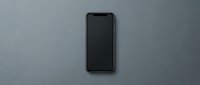 Modern smartphone with blank black screen isolated on gray background, ready for app mockups, web design, and digital marketing presentations.