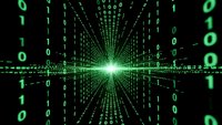 Digital binary code matrix with glowing green numbers radiating from bright central light point creating futuristic cyber technology data stream effect.