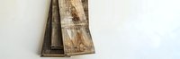 Rustic wooden planks with natural grain patterns and weathered texture against white background, suitable for interior design projects.