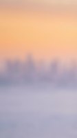 Soft gradient background transitioning from warm peachy tones at top to cool lavender and blue hues below, with blurred cityscape silhouette. Suitable for web design, presentations, and digital backgrounds.