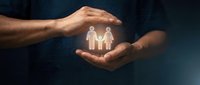 Hands of a dark-skinned man cupping a glowing family icon on a dark tech background, symbolizing protection, insurance, and care.