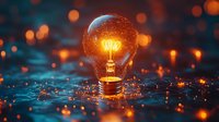 Glowing light bulb on water surface with orange bokeh lights and water drops creating magical atmosphere. Creative concept for innovation and ideas.