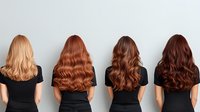 Women with different shades of brown and copper hair wearing black tops shown from behind, displaying various hair colors from blonde to dark brunette.