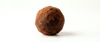 Chocolate truffle dusted with cocoa powder, isolated on white background for confectionery, bakery, dessert, and food packaging design projects.