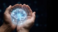 Hands holding glowing digital brain with neural network connections on dark background, representing artificial intelligence, technology innovation, and future computing solutions.