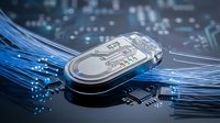 Transparent USB flash drive with circuit board design on blue digital technology background with glowing fiber optic cables and electronic components.
