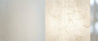 Elegant textured wallpaper with delicate floral pattern in warm beige tones creating sophisticated interior design atmosphere for modern home decor.