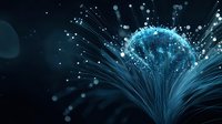 Glowing blue fiber optic network sphere with light rays against dark background, representing digital connectivity and global data transmission technology.