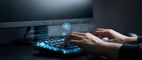 Businessman hands typing on laptop with AI artificial intelligence holographic interface and data visualization for machine learning technology.