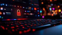 Red padlock icon on laptop keyboard with glowing backlight and bokeh background, representing cybersecurity and digital data protection in dark environment.