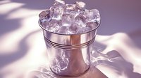 Metal bucket filled with crystal clear ice cubes casting soft purple shadows on white surface, minimalist composition with elegant lighting for beverage and cocktail photography.