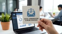 Business professional holding digital communication strategy card with email icon in modern office workspace for marketing campaigns and online business growth.