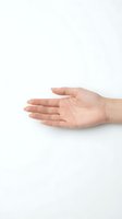 Open palm of Caucasian woman's hand gesturing offering, giving, or presenting something against neutral white background for healthcare, charity, or support concepts.