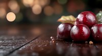 Fresh ripe cherries with water drops on rustic wooden surface against blurred bokeh background, macro food photography for restaurant menu design.