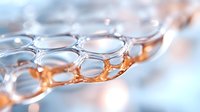 Macro photography of transparent bubble pattern with soft orange and blue reflections creating abstract geometric shapes and light effects in scientific research.