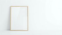 Empty wooden frame mockup on white wall for artwork display and interior design projects.