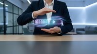 Businessman in dark suit holding glowing battery icon with charging indicator between hands at wooden desk in modern office, representing energy management and power technology solutions.