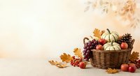 Autumn harvest basket with pumpkins, gourds, apples and colorful fall leaves on warm beige background with copy space for seasonal decorating and thanksgiving.