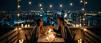 Romantic couple enjoying candlelit dinner on rooftop terrace with city skyline view and string lights creating intimate atmosphere for special occasion.