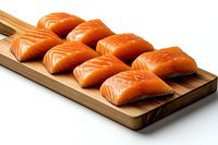 Fresh raw salmon fillets arranged on wooden cutting board against white background, showcasing vibrant orange color and clean presentation for culinary use.