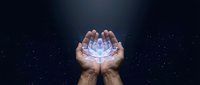Hands holding glowing lotus flower with ethereal light effects against dark starry background for meditation, spirituality and wellness concepts.