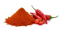 Red chili pepper powder pile with fresh hot peppers isolated on white background for cooking spice seasoning culinary ingredient kitchen design.