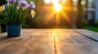 Spring tulips in blue pot on wooden table at sunset, with golden sunburst and bokeh background creating warm atmospheric garden scene.