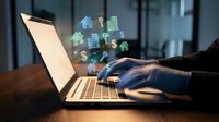 Businessman using laptop with floating real estate icons and digital property symbols for online investment and virtual housing market technology.