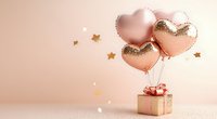 Rose gold heart balloons floating above gift box with golden stars on pink background for romantic celebrations and special occasions.