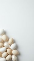 Fresh organic eggs in natural beige and white tones scattered on clean white background with copy space for Easter holiday cooking and farm products.
