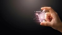 Hand holding glowing shopping cart icon with growth chart and success text, symbolizing e-commerce business growth and retail strategy.