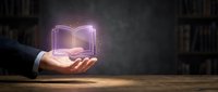 Businessman hand holding glowing digital book hologram above palm in library setting. Concept of e-learning, digital education and knowledge technology.