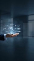 Businessman hand holding digital shield with security icons and data protection interface for cybersecurity, network safety, and business technology solutions.