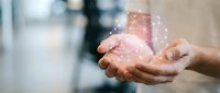 Caucasian male hands holding a glowing digital network globe, symbolizing global connectivity, technology, and innovation in business.