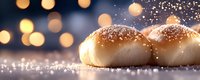 Fresh baked bread rolls dusted with powdered sugar against dark background with golden bokeh lights creating magical holiday atmosphere.