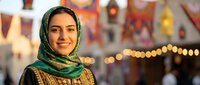 Young Middle Eastern woman wearing traditional green headscarf smiling warmly at camera with colorful market lights creating bokeh background atmosphere.