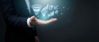 Businessman hand presenting glowing funnel with conversion icons floating above palm against dark background for marketing analytics and sales optimization.