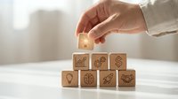 Business professional hand placing lightbulb icon wooden block on stack representing innovation strategy and creative problem solving in corporate environment.