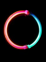 Glowing neon circle frame in vibrant red and blue colors on black background, creating dynamic light trail effect for modern design projects.