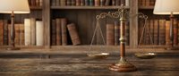 Vintage brass scales of justice on wooden desk in classic library with antique law books for legal services and attorney office decoration.