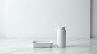 Minimalist white cosmetic bottles and soap bar on marble surface, isolated on white background for skincare product packaging design and branding mockups.